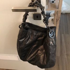 A dark grey/silver Michael Kors bag